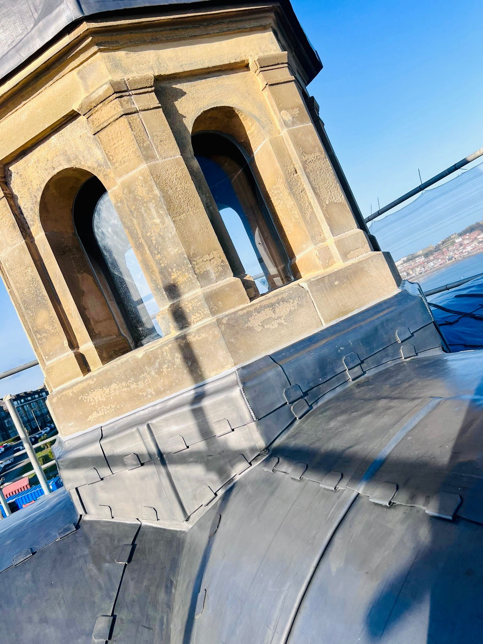 Clipped lead flashing detail with welted panels to a historic coastal clock tower
