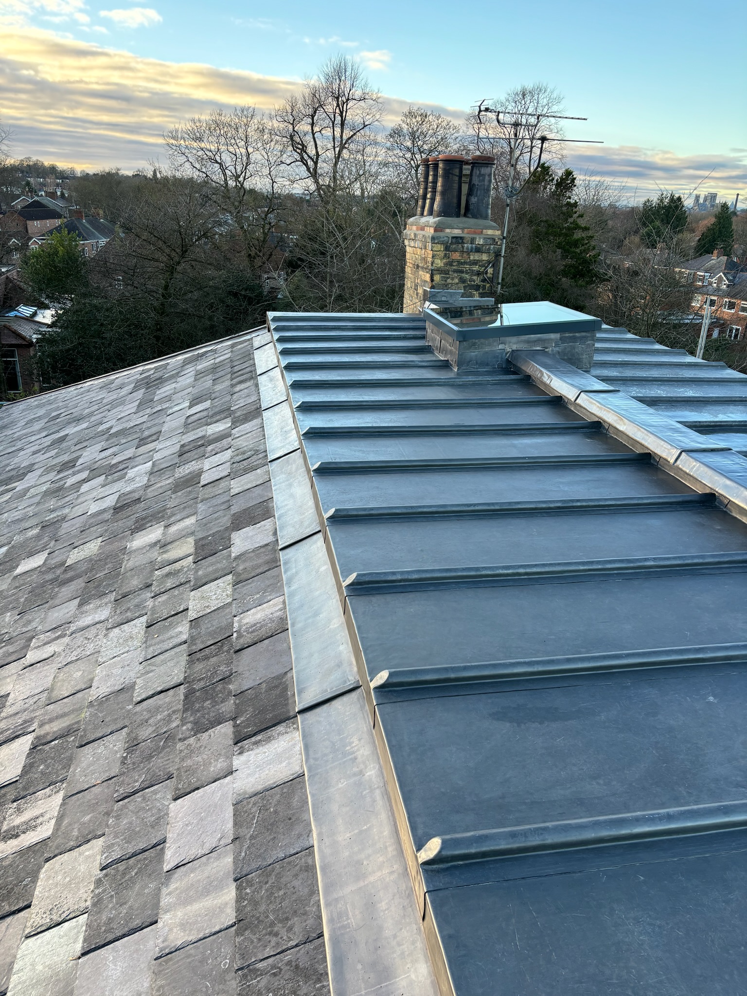 Apron flashing formed in welted panels wrapped around a continuous stainless steel clip