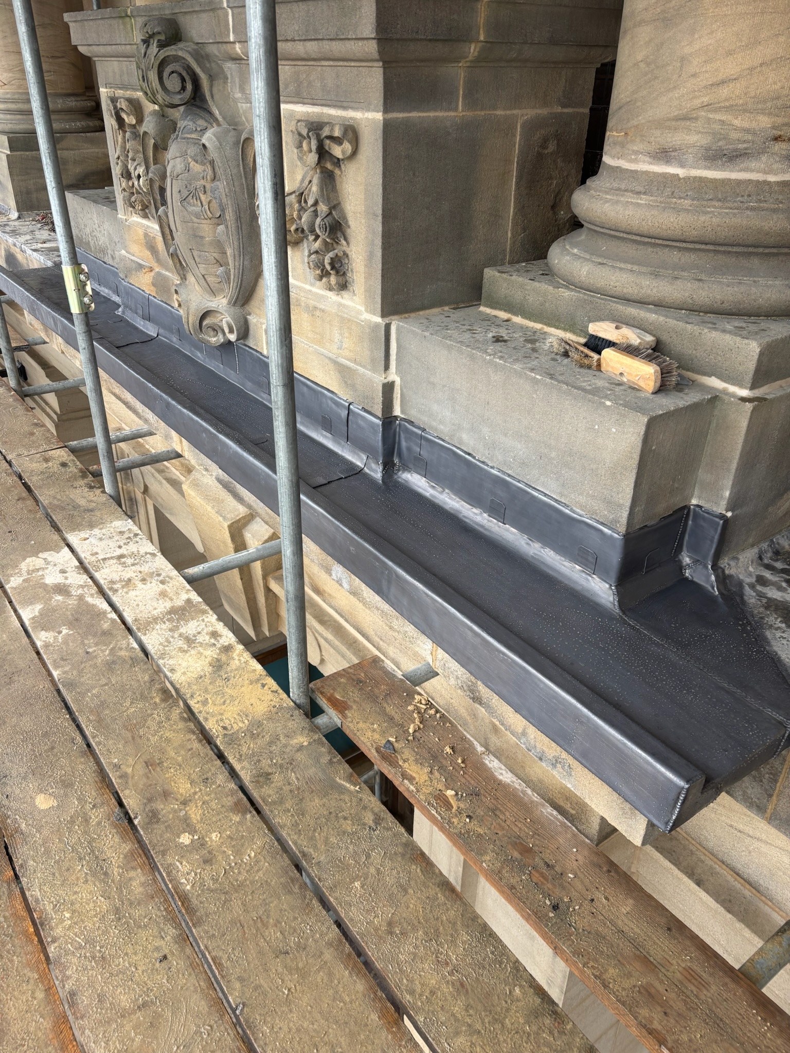 Lead detail to a stone plinth with clipped front edge